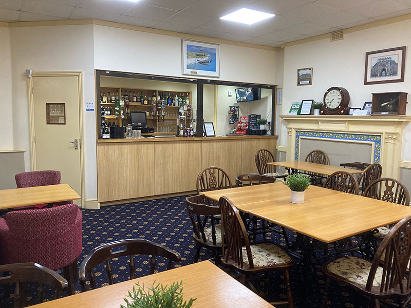 The licensed bar counter with tables in front