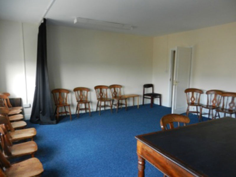 A breakout room with chairs and a meeting table